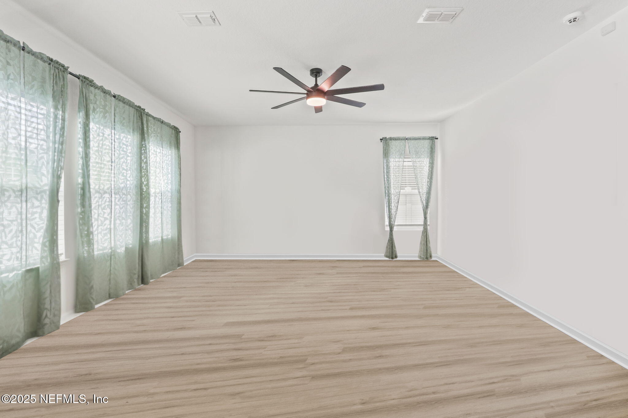 2267 Shady Breeze Ln Green Cove Springs Green Cove Springs, FL 32043 - Photo 12 of 17 a view of a livingroom with a ceiling fan & hardwood floor