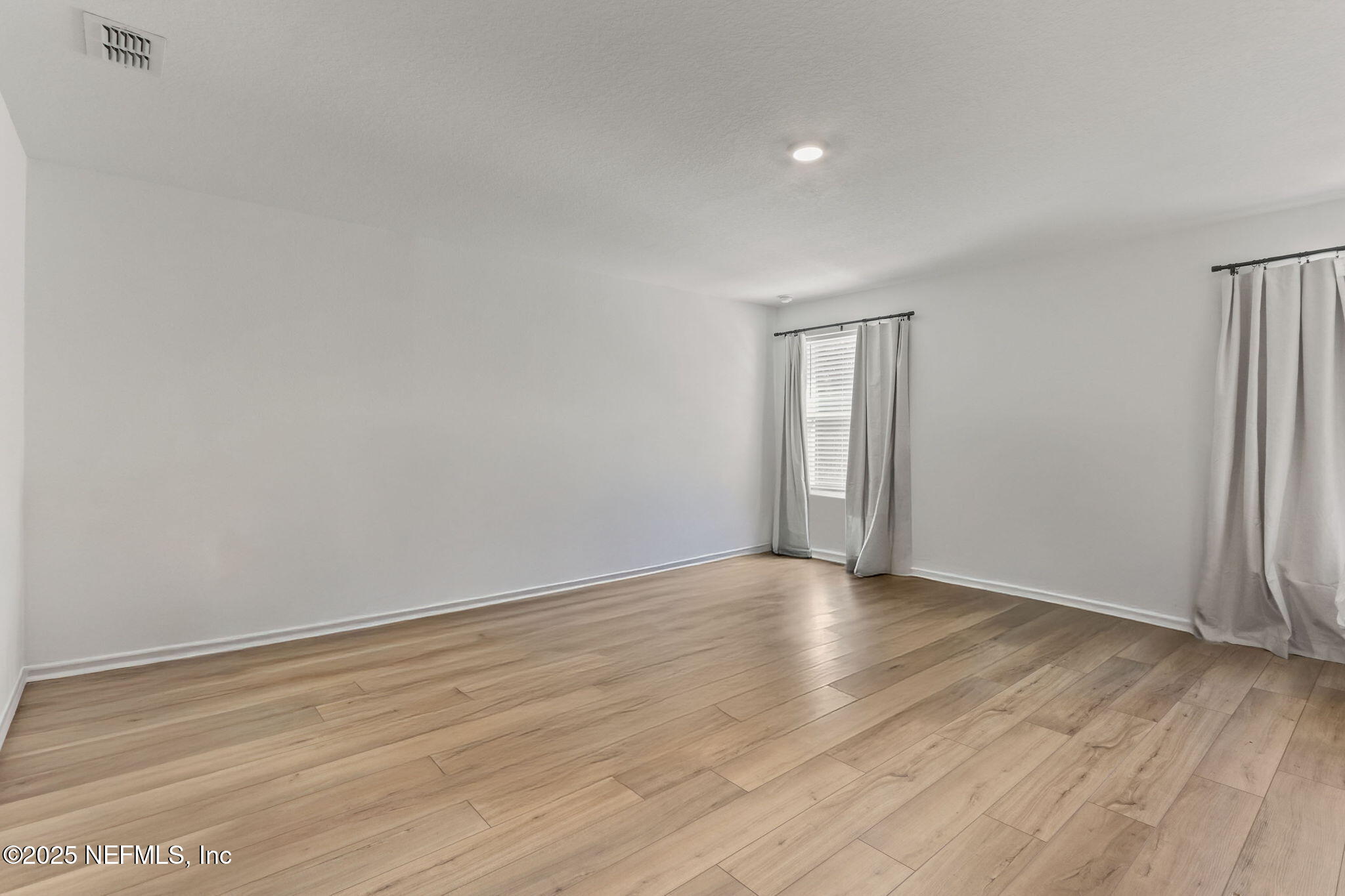 2267 Shady Breeze Ln Green Cove Springs Green Cove Springs, FL 32043 - Photo 15 of 17 a view of an empty room with wooden floor and a window