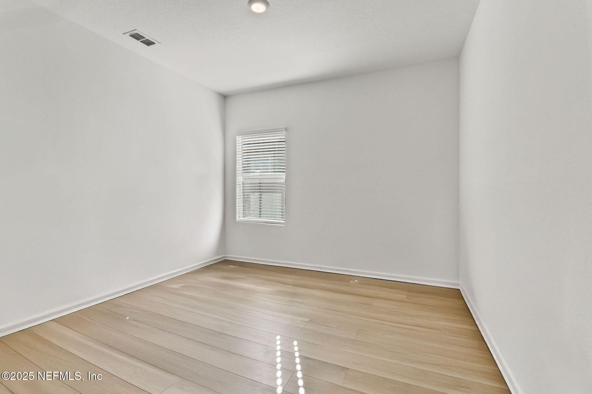 2267 Shady Breeze Ln Green Cove Springs Green Cove Springs, FL 32043 - Photo 8 of 17 a view of an empty room with wooden floor and a window