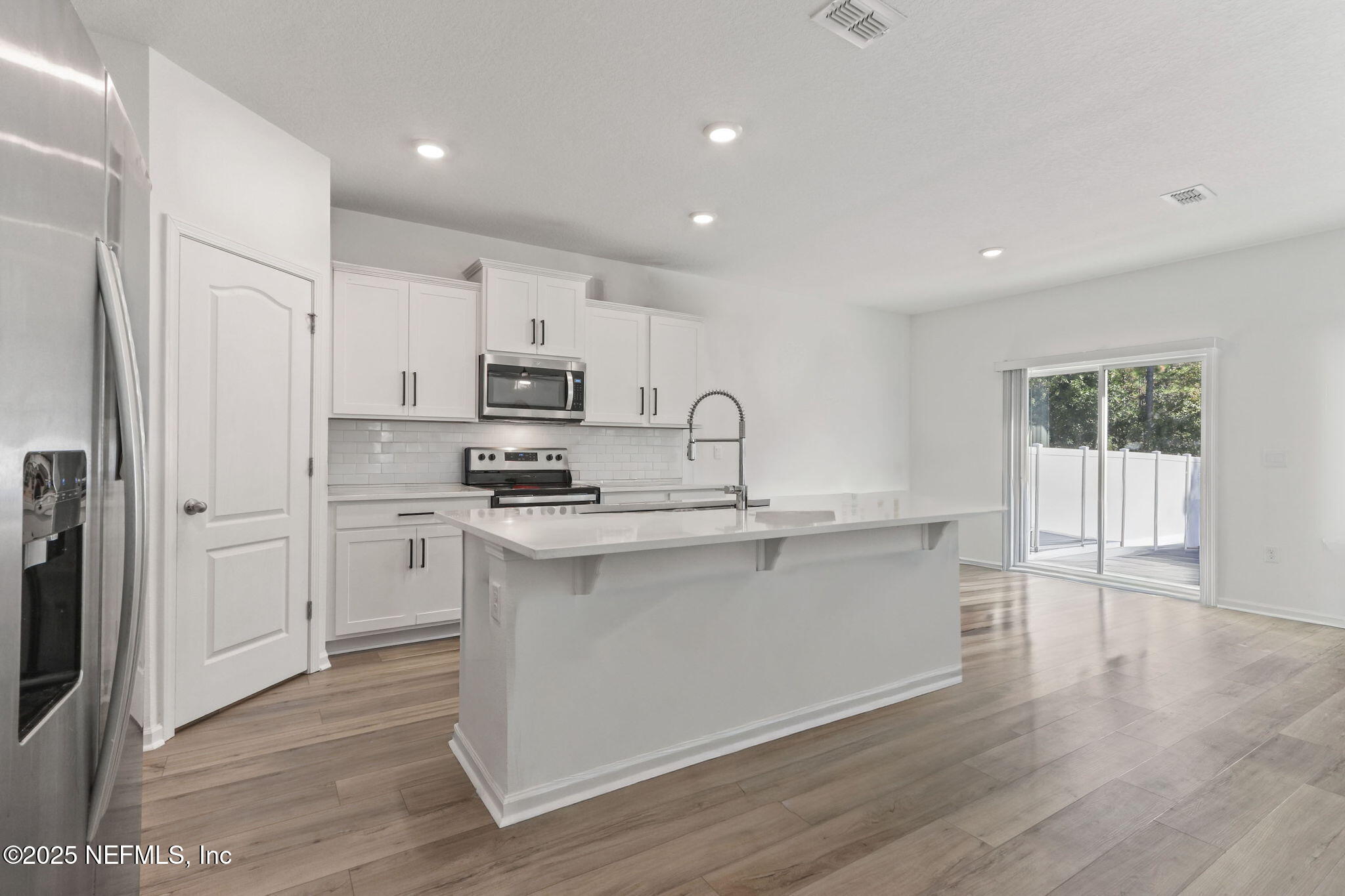 2267 Shady Breeze Ln Green Cove Springs Green Cove Springs, FL 32043 - Photo 9 of 17 a kitchen with stainless steel appliances granite countertop a sink a stove a refrigerator and cabinets