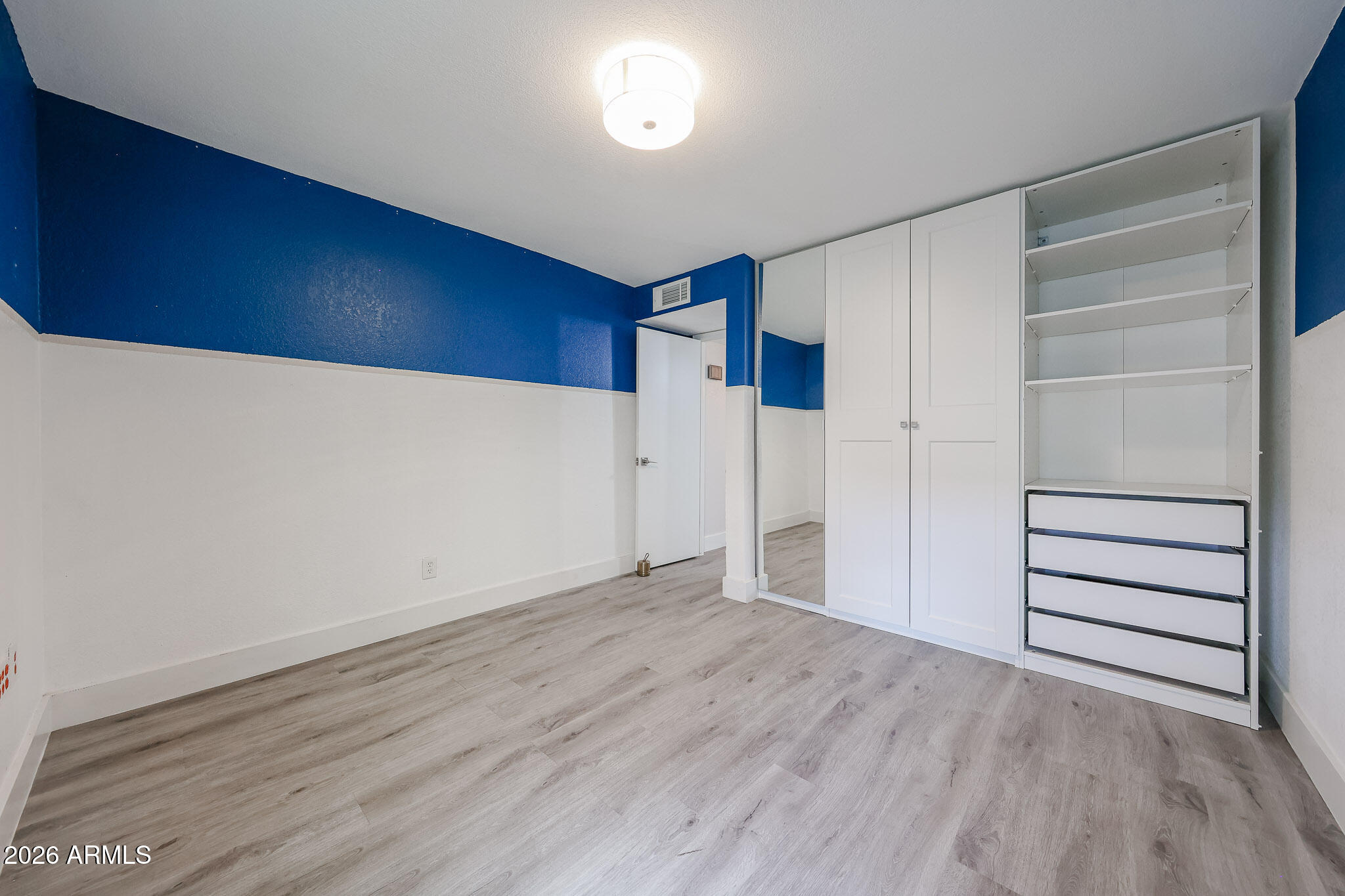 5114 East Monte Vista Road Phoenix, AZ 85008 - Photo 26 of 45 a view of an empty room with wooden floor
