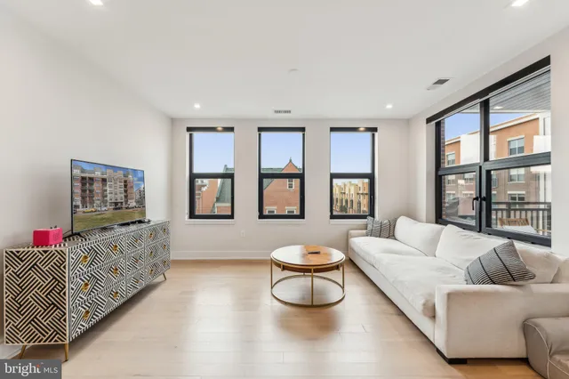 a living room with furniture and a large window