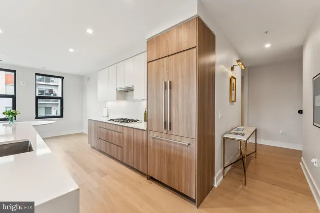 a kitchen with stainless steel appliances granite countertop a refrigerator and a sink