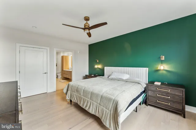 a bedroom with a bed and ceiling fan