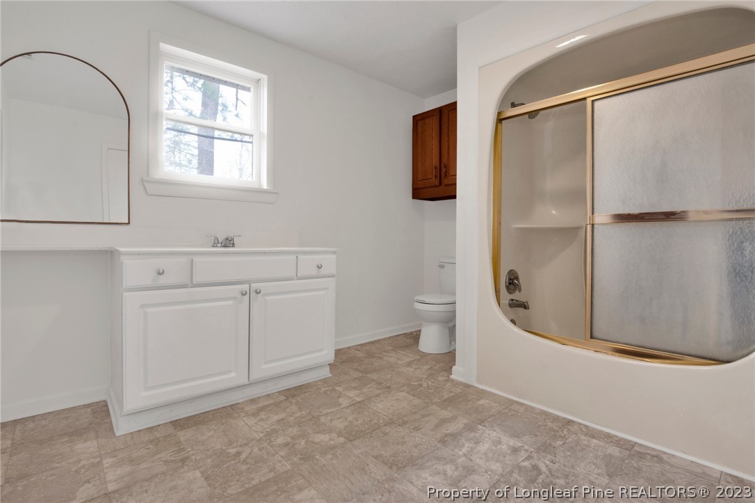997 Balfour Road Red Springs, NC 28377 - Photo 14 of 15 a view of a bathroom with a sink and mirror