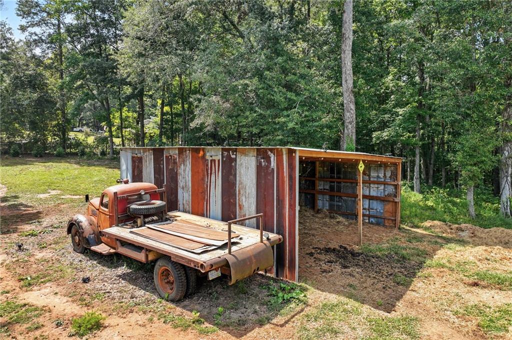 731 Borders Road Commerce, GA 30530 - Photo 14 of 75 a wooden bench sitting in the middle of a yard