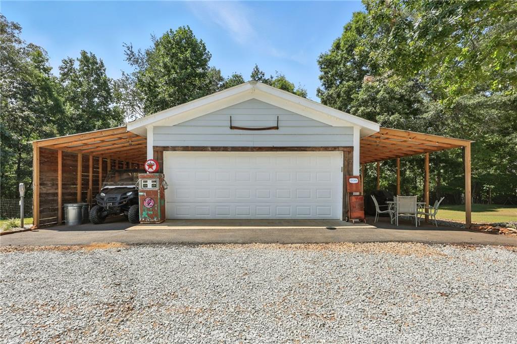 731 Borders Road Commerce, GA 30530 - Photo 34 of 75 a view of a house with a backyard and a large tree