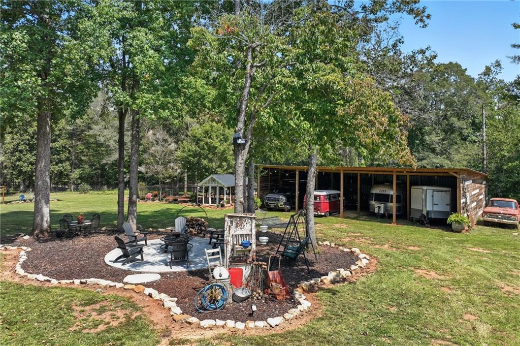 731 Borders Road Commerce, GA 30530 - Photo 35 of 75 a view of a house with backyard porch and sitting area