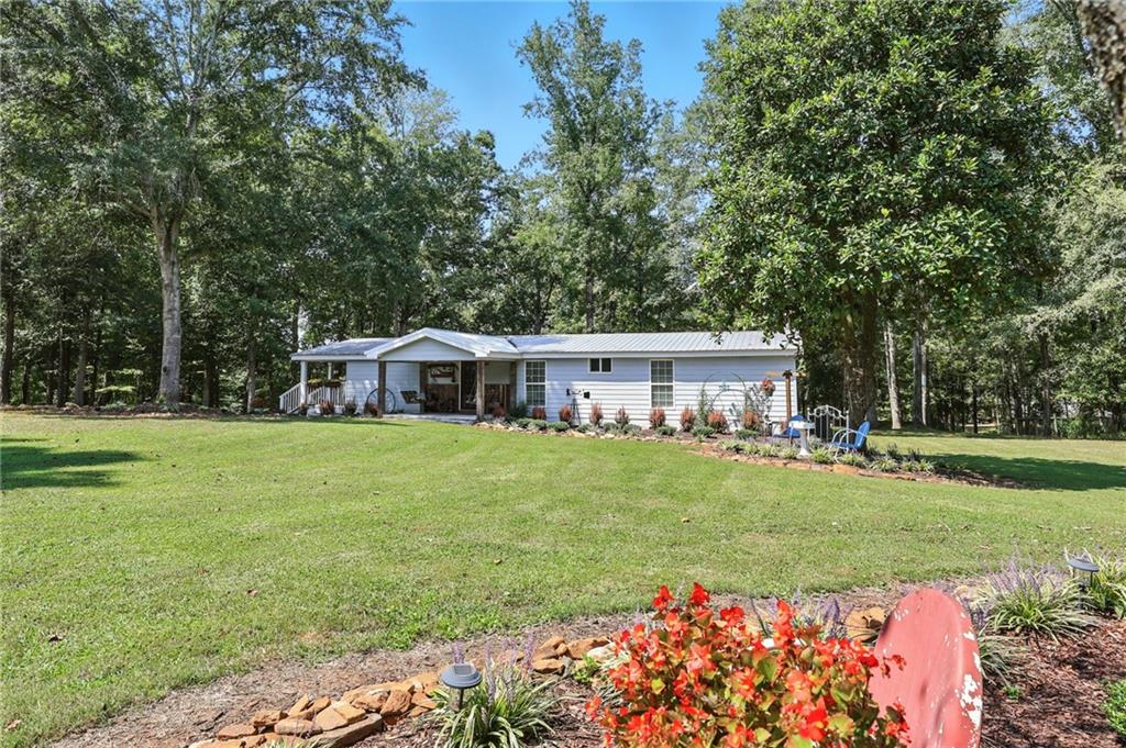 731 Borders Road Commerce, GA 30530 - Photo 46 of 75 a view of a house with a big yard and large trees