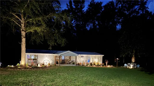 a kitchen with stainless steel appliances granite countertop a refrigerator a stove oven a sink dishwasher and white cabinets with wooden floor