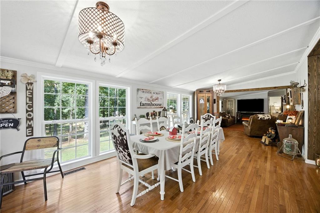 731 Borders Road Commerce, GA 30530 - Photo 55 of 75 a view of a dining room with furniture wooden floor and chandelier