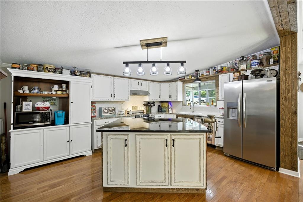 731 Borders Road Commerce, GA 30530 - Photo 58 of 75 a kitchen with stainless steel appliances granite countertop a sink and a refrigerator