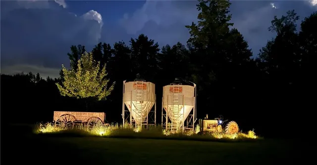 a wooden bench sitting in the middle of a yard