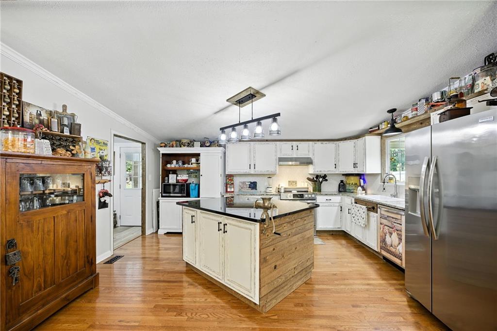 731 Borders Road Commerce, GA 30530 - Photo 72 of 75 a kitchen with cabinets and wooden floor