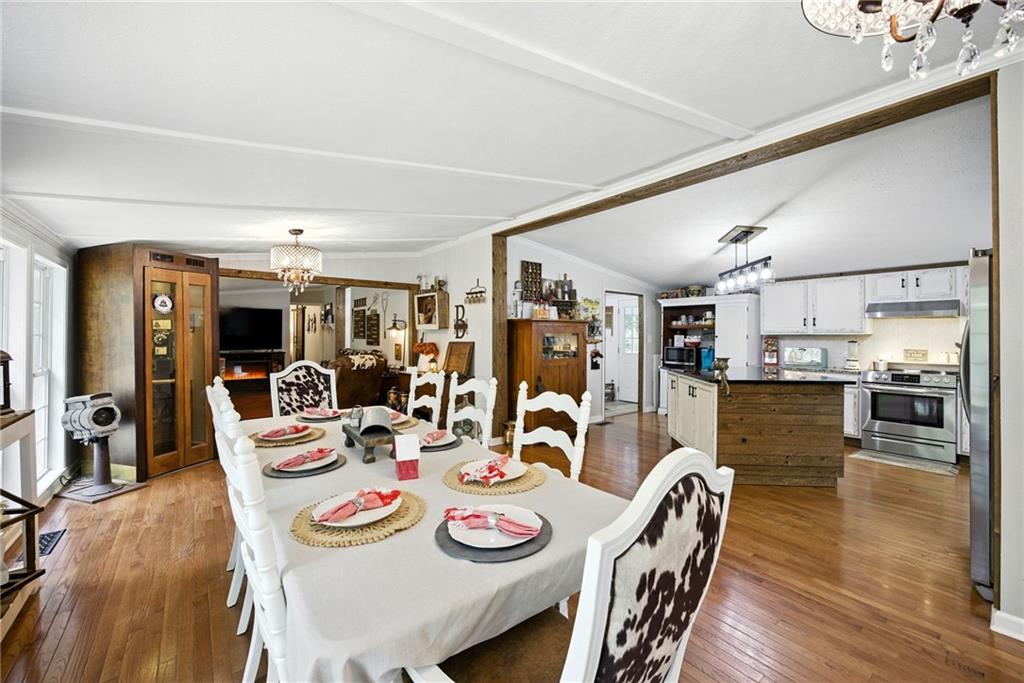731 Borders Road Commerce, GA 30530 - Photo 75 of 75 a dining room with furniture a kitchen view and wooden floor