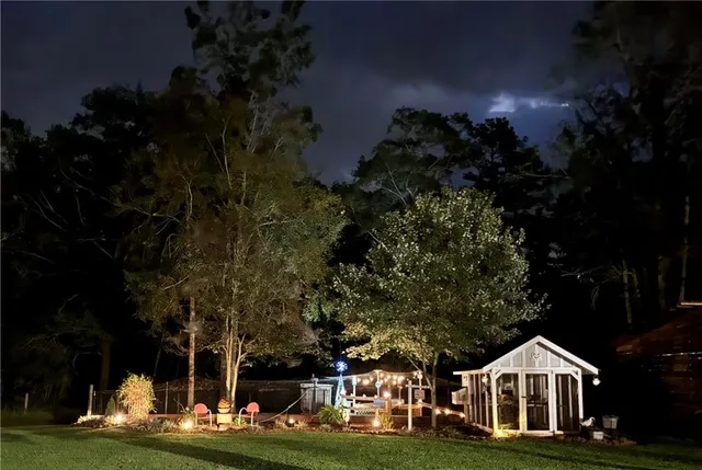 an aerial view of residential houses with outdoor space and trees