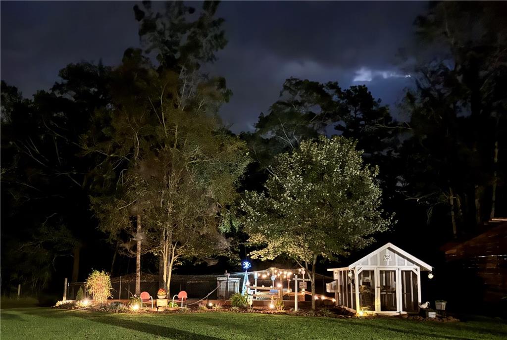 731 Borders Road Commerce, GA 30530 - Photo 10 of 75 a front view of a house with a garden and trees