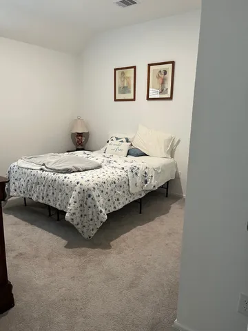 a bed sitting in a bedroom next to a small yard