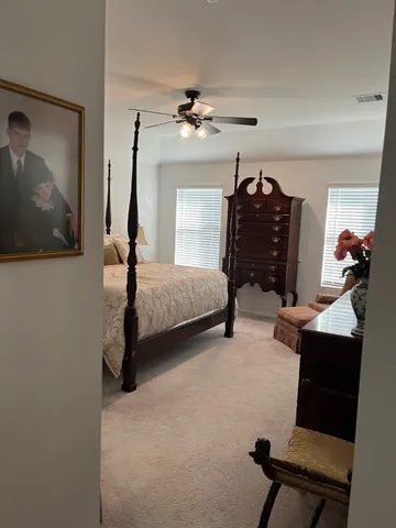 a bedroom with bed and window