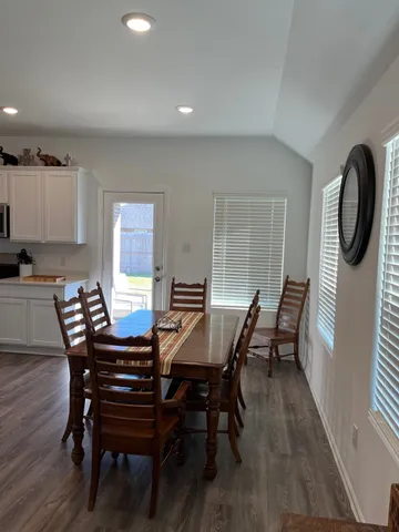 a view of a dining room with furniture and wooden floor