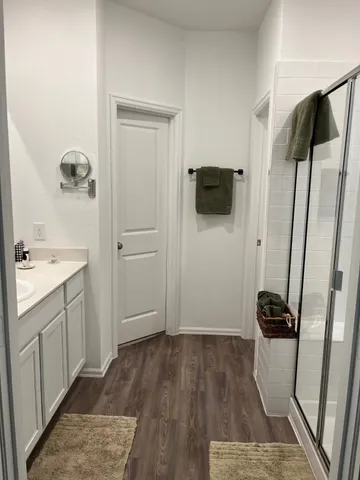 a view of bathroom with a sink and mirror