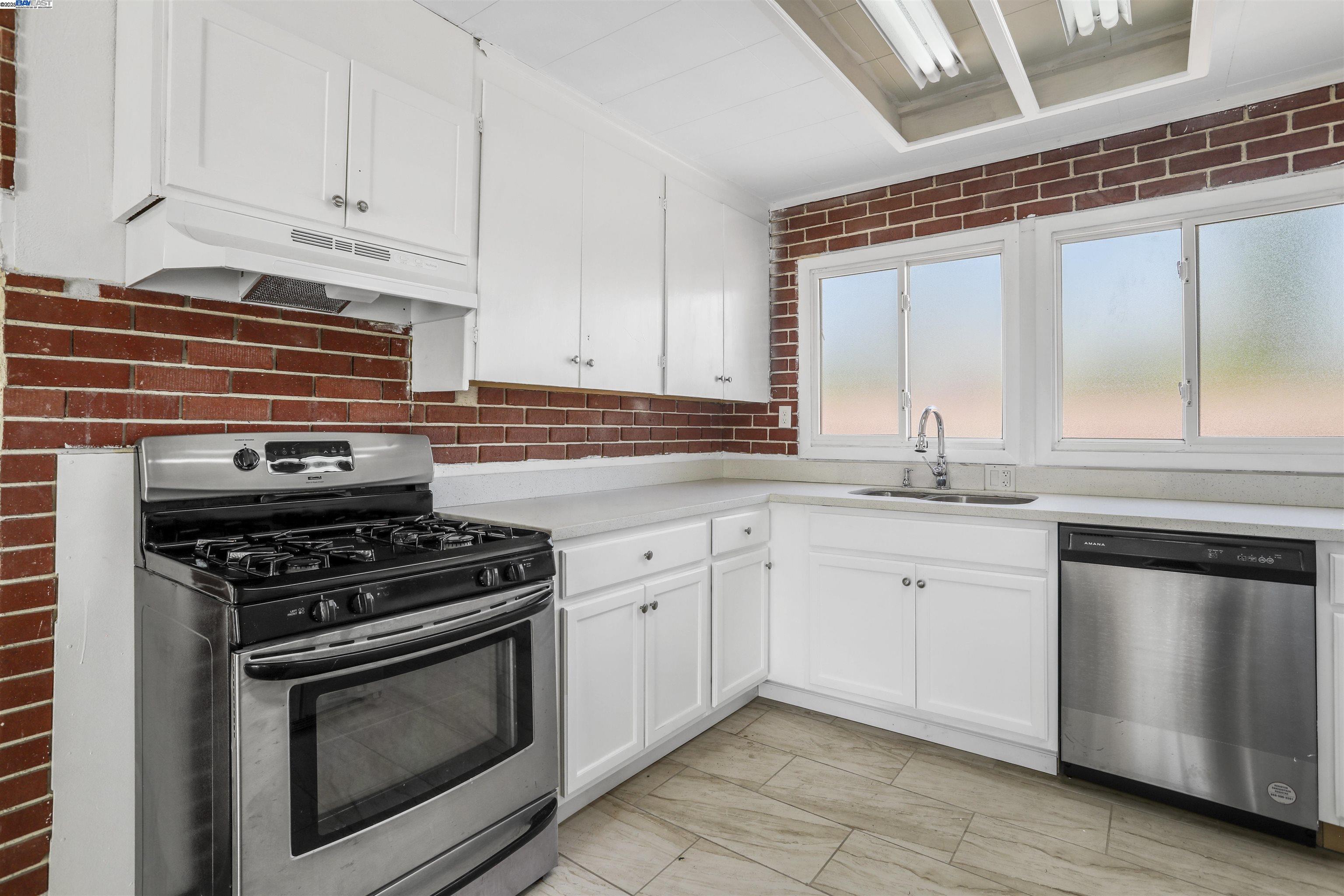 1925 Alpha Way Antioch, CA 94509 - Photo 14 of 26 a kitchen with granite countertop white cabinets and appliances