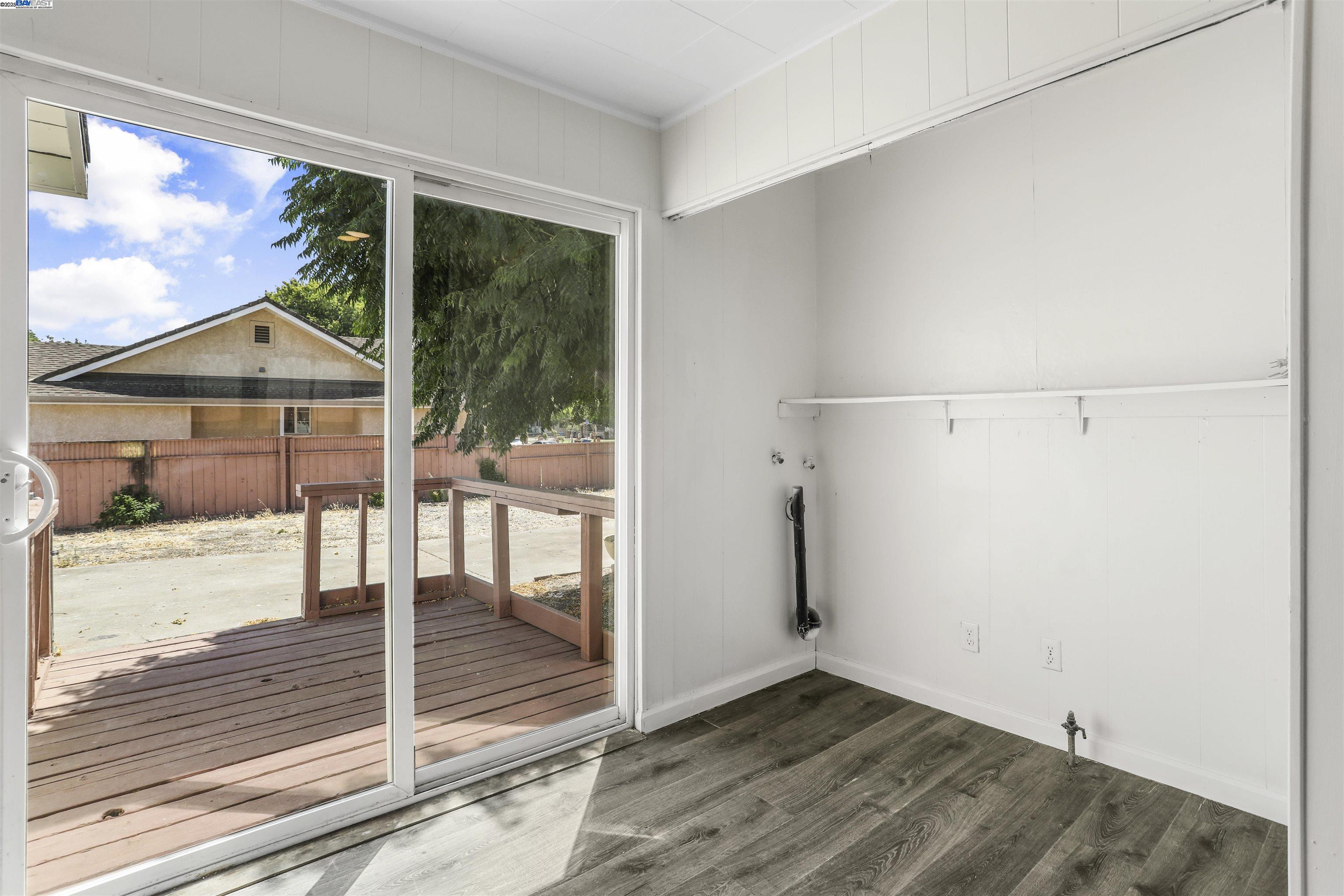 1925 Alpha Way Antioch, CA 94509 - Photo 17 of 26 an empty room with wooden floor and outdoor space