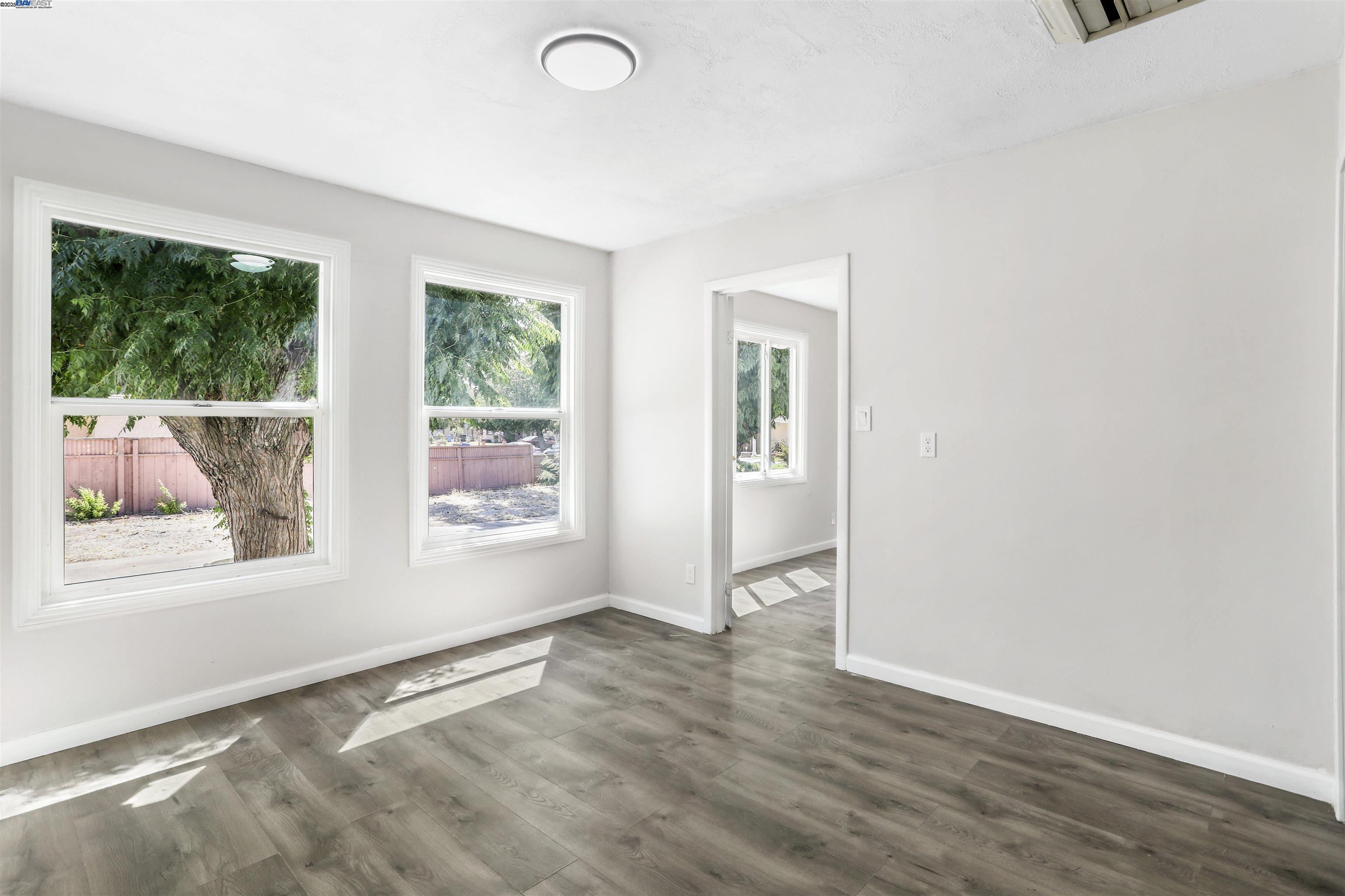 1925 Alpha Way Antioch, CA 94509 - Photo 7 of 26 an empty room with wooden floor and windows