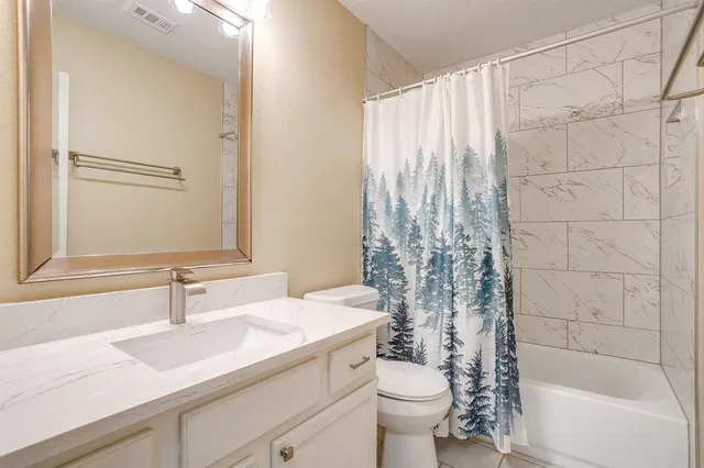 a bathroom with a sink toilet a mirror and shower