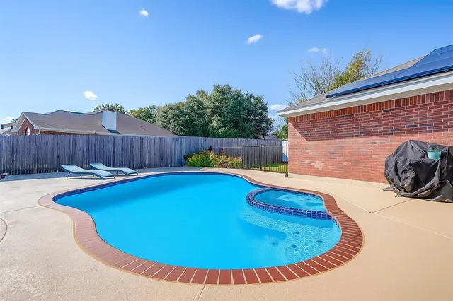 a view of a swimming pool with a lounge chairs