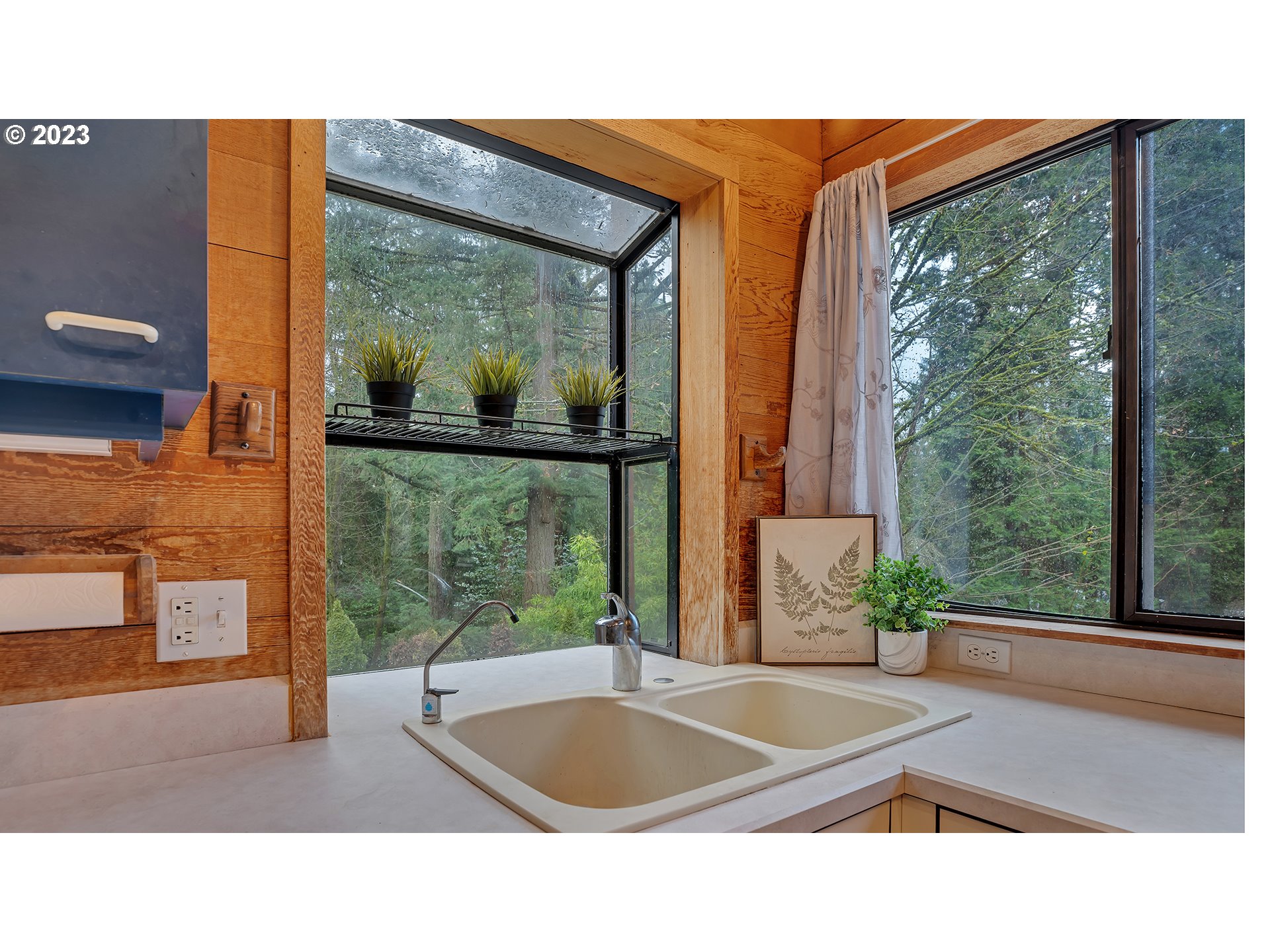 660 Southwest Maplecrest Drive Portland, OR 97219 - Photo 18 of 32 a picture of a living room and floor to ceiling window