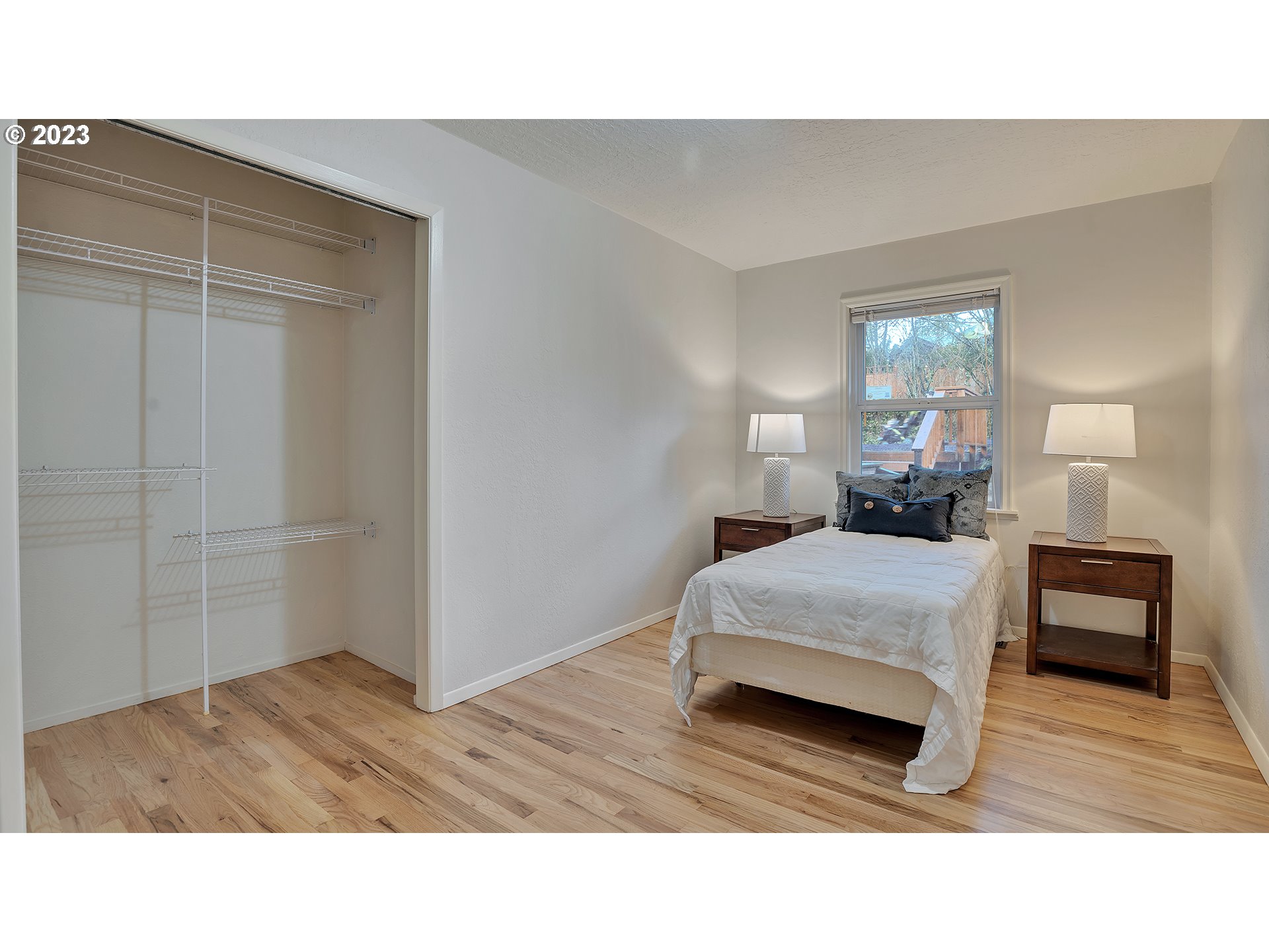 660 Southwest Maplecrest Drive Portland, OR 97219 - Photo 25 of 32 a bedroom with a bed and wooden floor