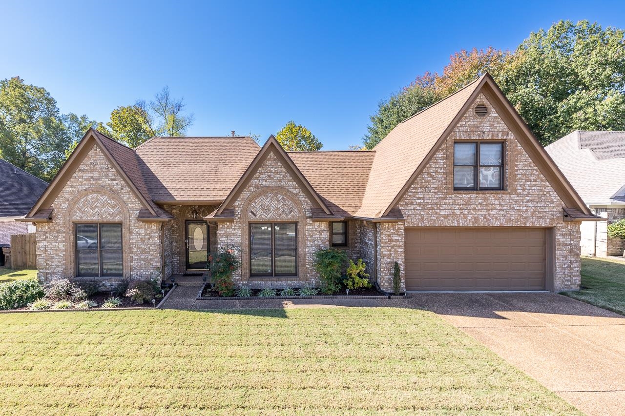 9113 Raspberry Lane Cordova, TN 38016 - Photo 1 of 25 a front view of a house with a yard