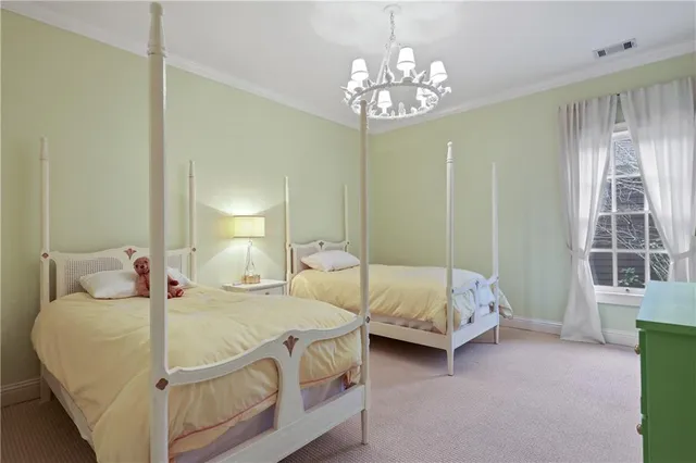 a bed room with a bed and a chandelier