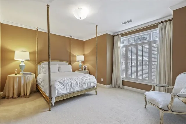 a spacious bedroom with a bed and window