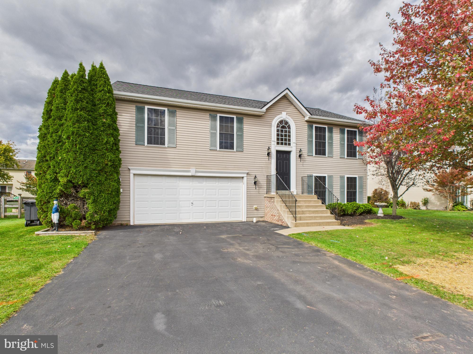 64 Bancroft Street Taneytown, MD 21787 - Photo 1 of 29 a front view of a house with a yard and garage