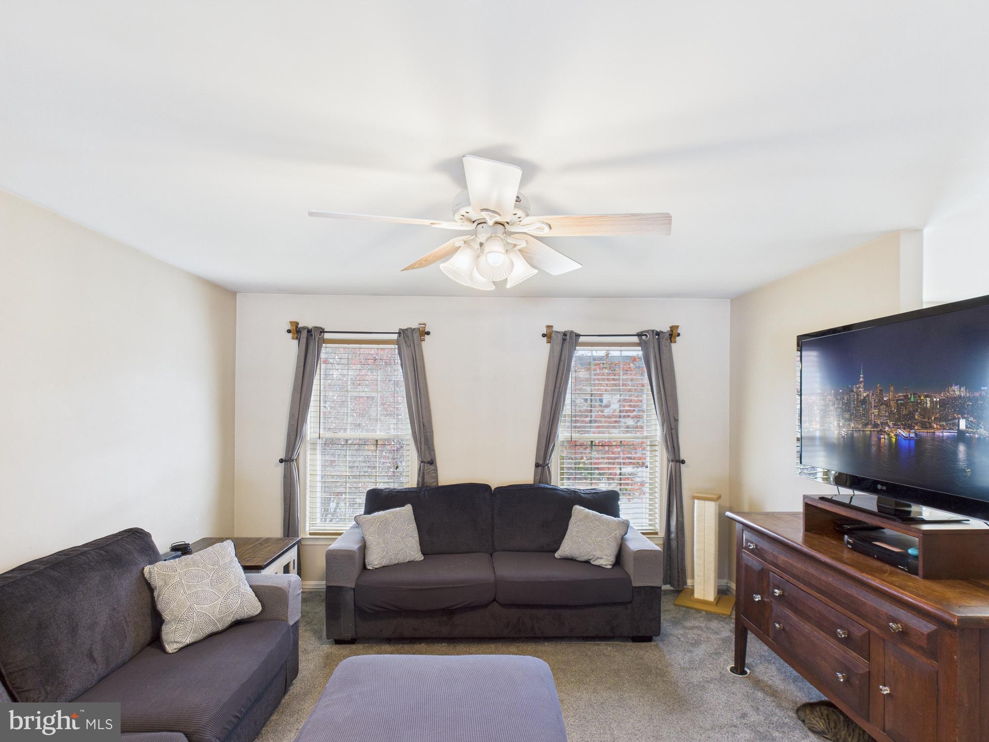 64 Bancroft Street Taneytown, MD 21787 - Photo 11 of 29 a living room with furniture and a flat screen tv
