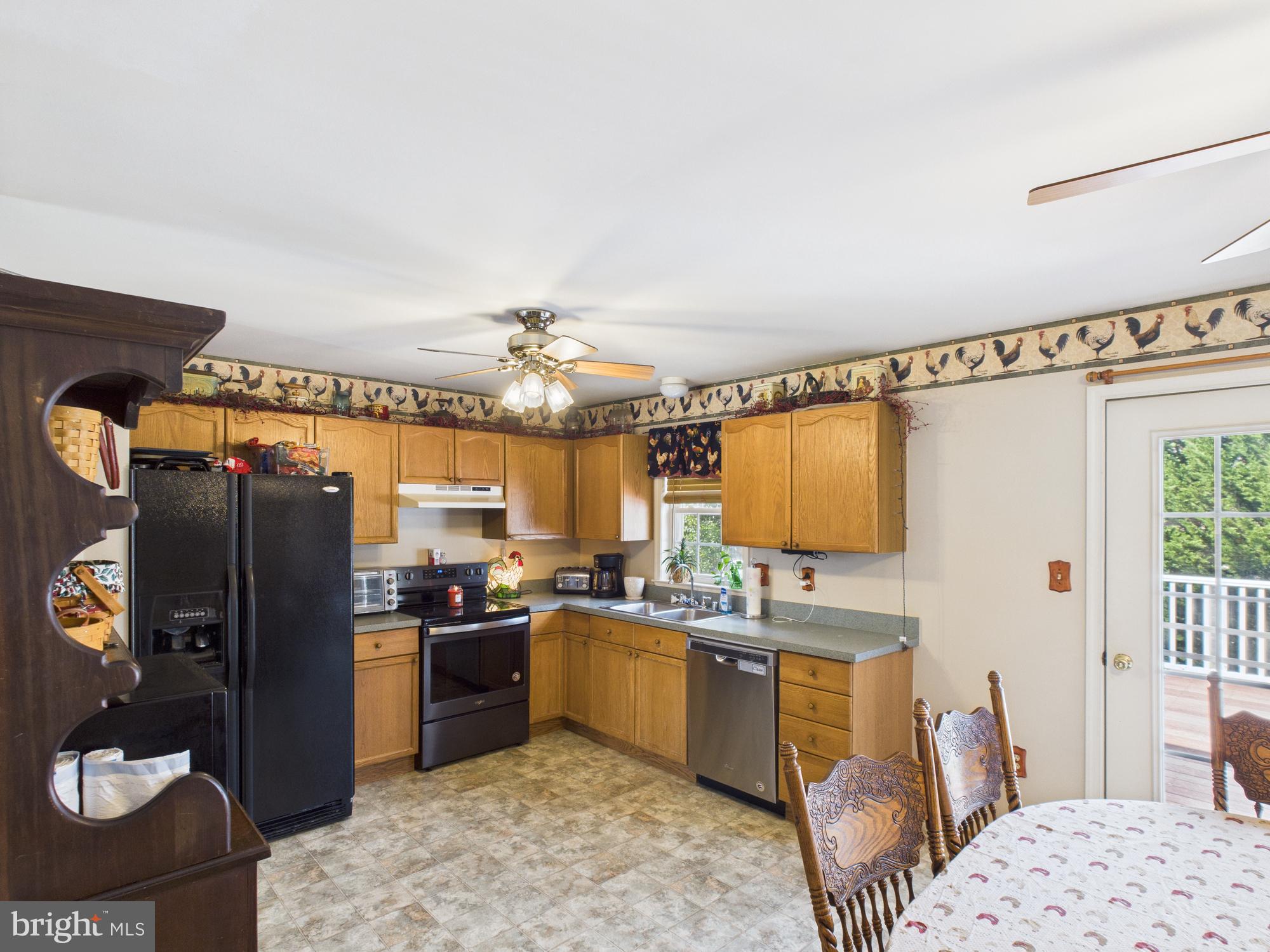 64 Bancroft Street Taneytown, MD 21787 - Photo 14 of 29 a kitchen with stainless steel appliances kitchen island granite countertop a refrigerator and a stove