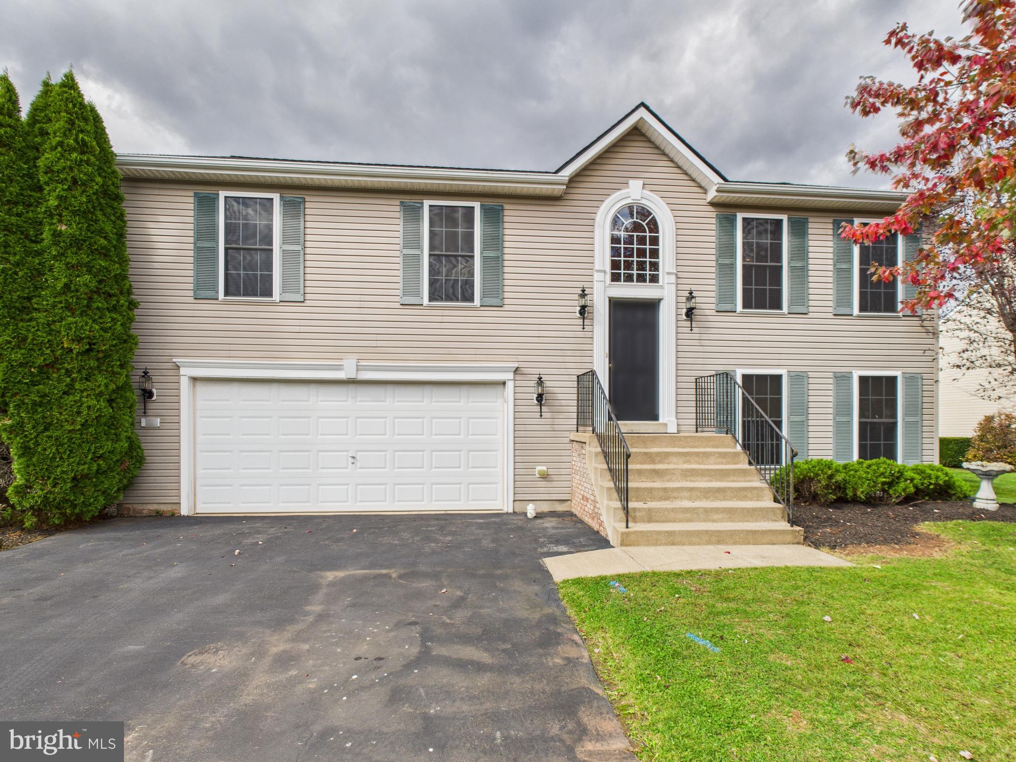 64 Bancroft Street Taneytown, MD 21787 - Photo 2 of 29 a front view of a house with a yard and garage