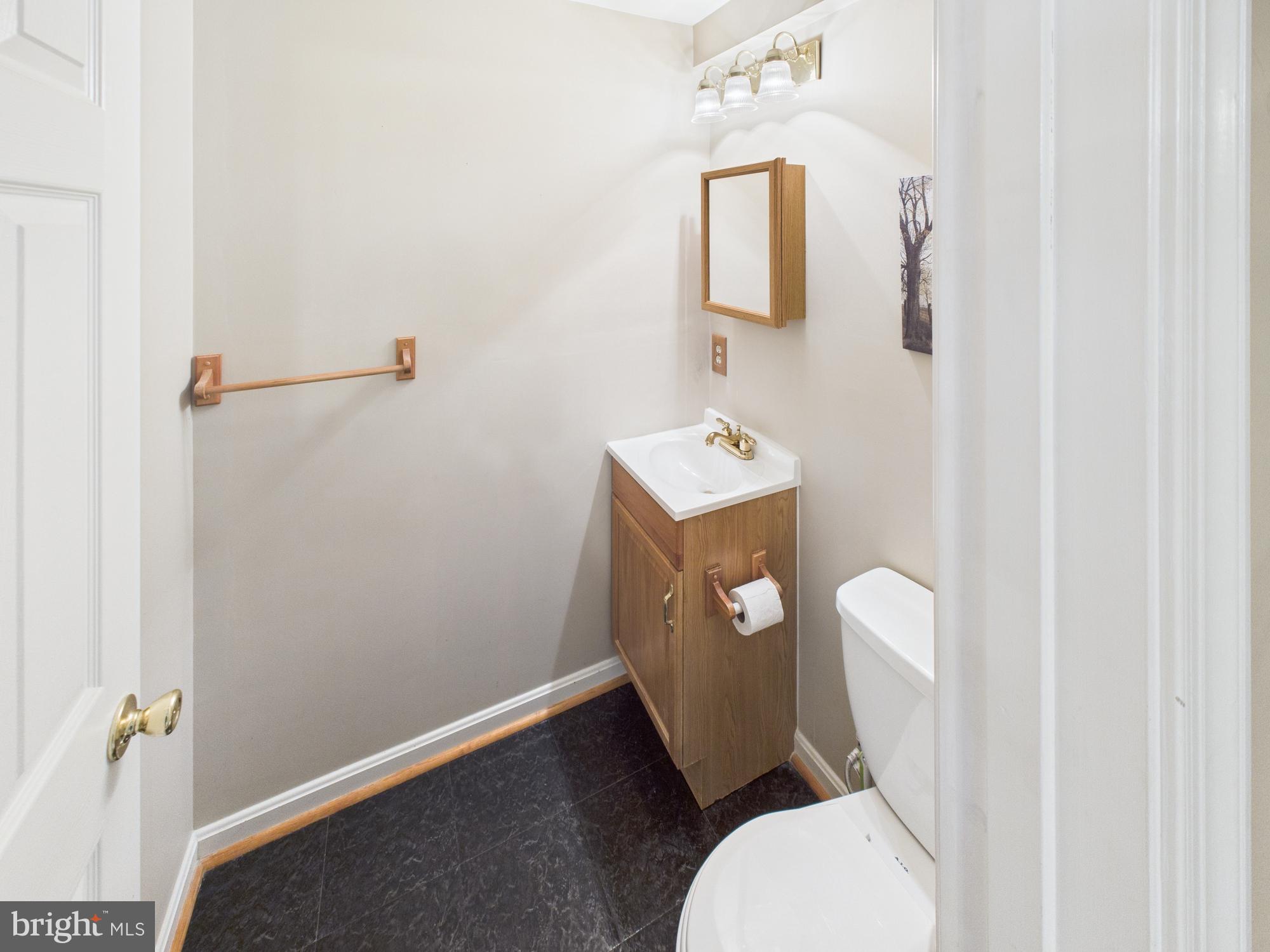64 Bancroft Street Taneytown, MD 21787 - Photo 26 of 29 a white toilet sitting next to a bathroom sink