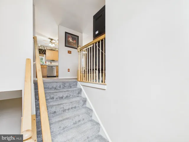 a view of a hallway with wooden floor and entryway