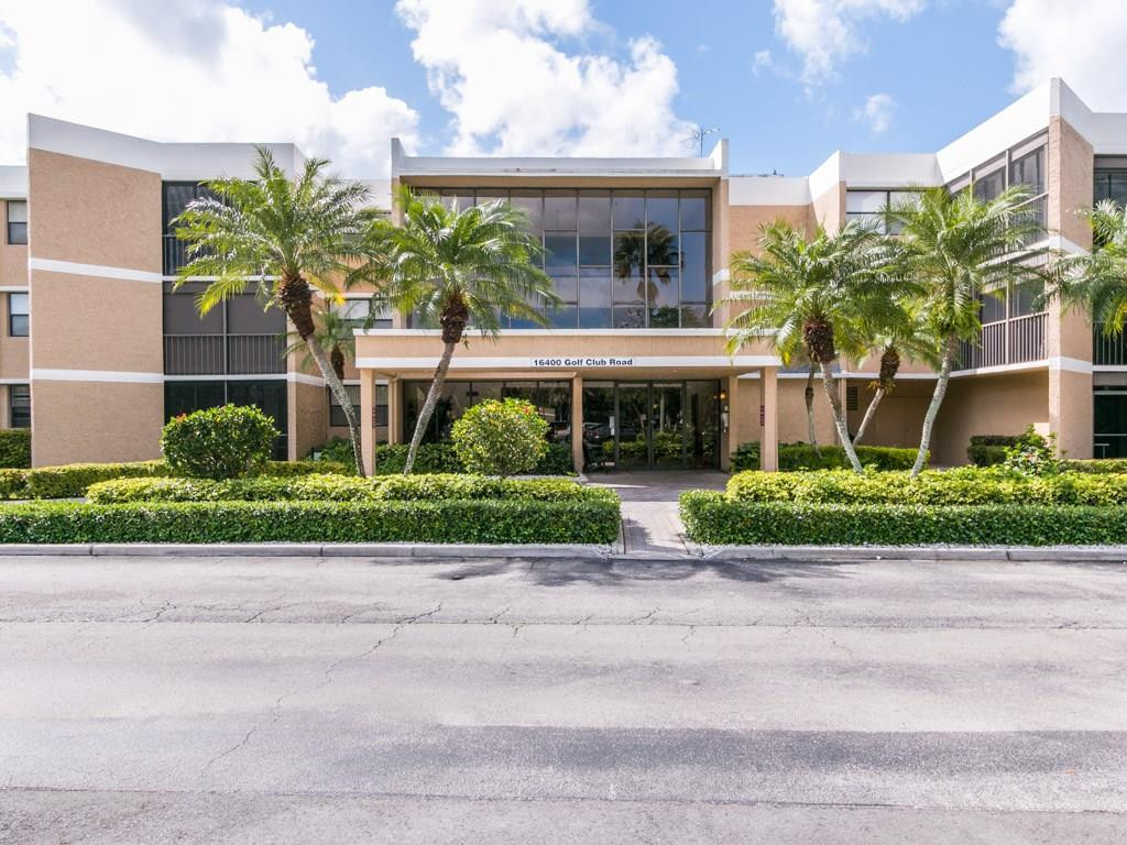16400 Golf Club Road, Unit 204 Weston, FL 33326 - Photo 1 of 31 a front view of a house with a yard and potted plants
