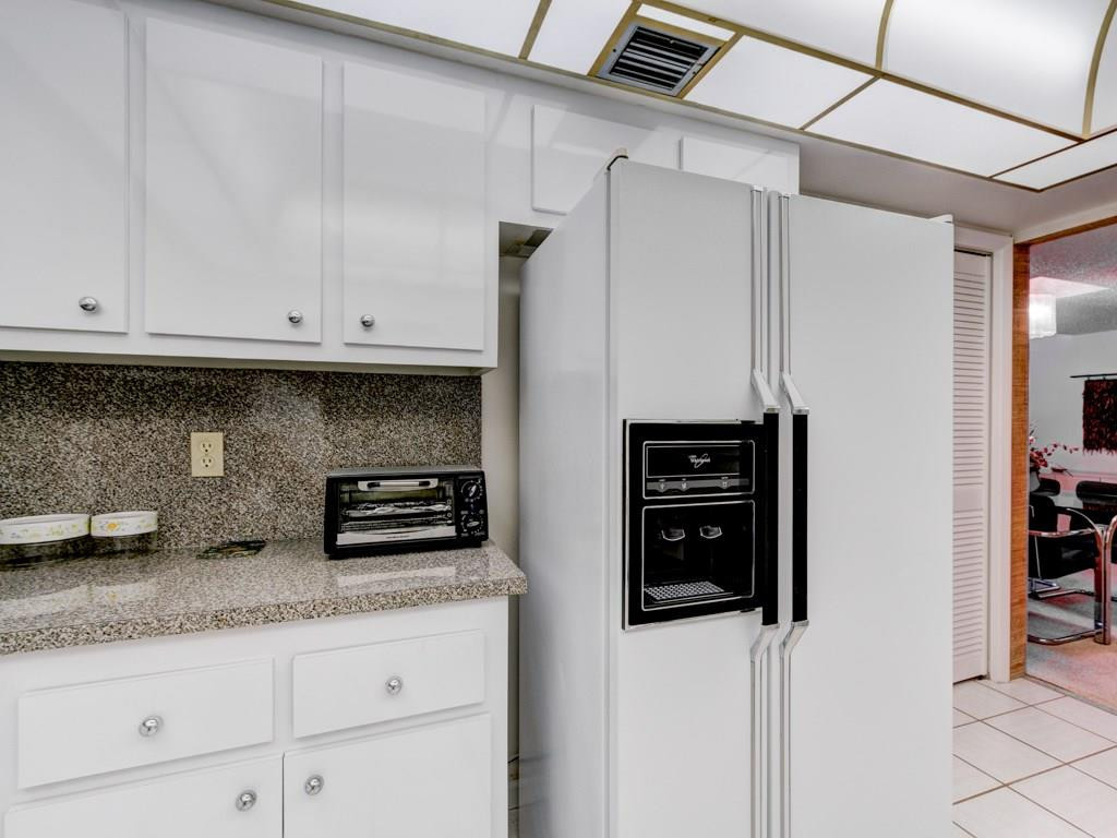16400 Golf Club Road, Unit 204 Weston, FL 33326 - Photo 18 of 31 a kitchen with stainless steel appliances granite countertop a refrigerator and white cabinets