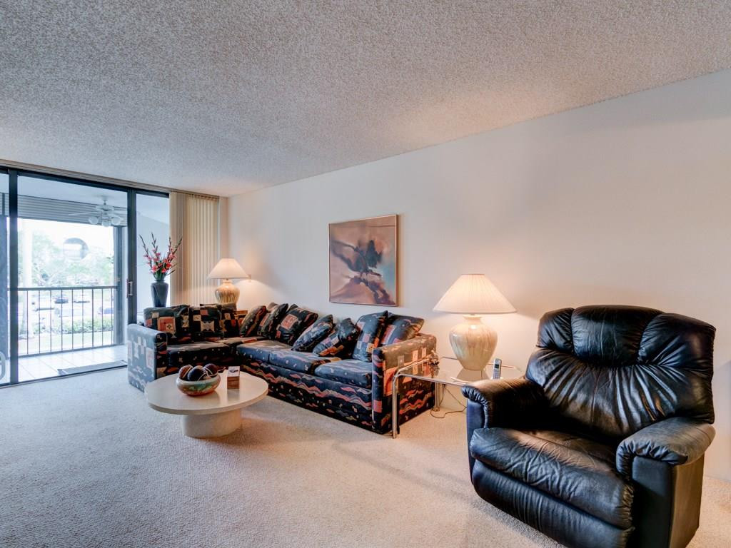 16400 Golf Club Road, Unit 204 Weston, FL 33326 - Photo 7 of 31 a living room with furniture and a lamp