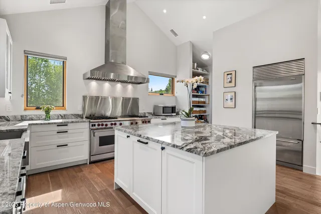a kitchen with a stove a sink and a refrigerator