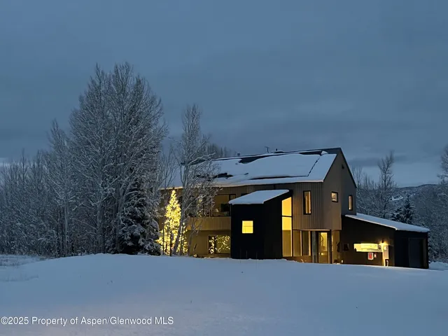 a view of building with car parked