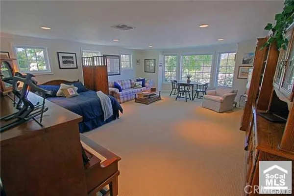 a living room with furniture a window and a flat screen tv