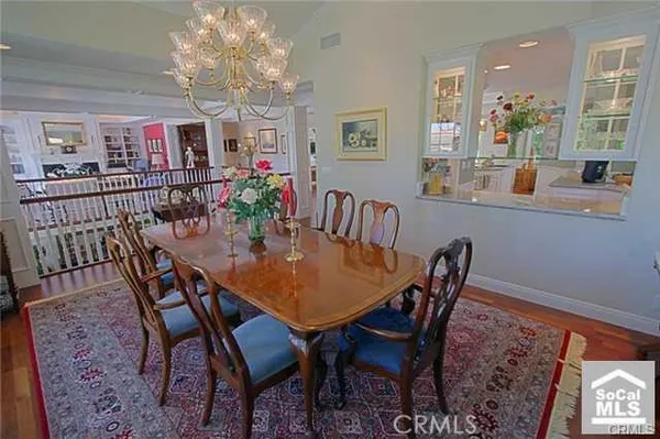 a view of a dining room with furniture and a chandelier