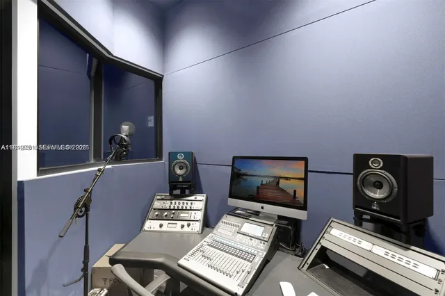 a living room with couches flat screen tv and a large window