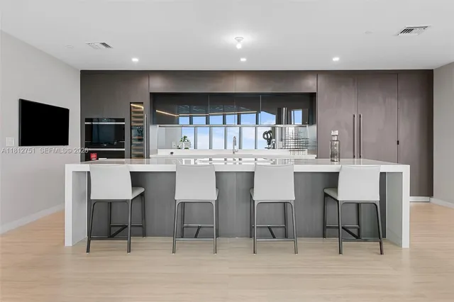 a kitchen with a sink counter top space appliances and cabinets